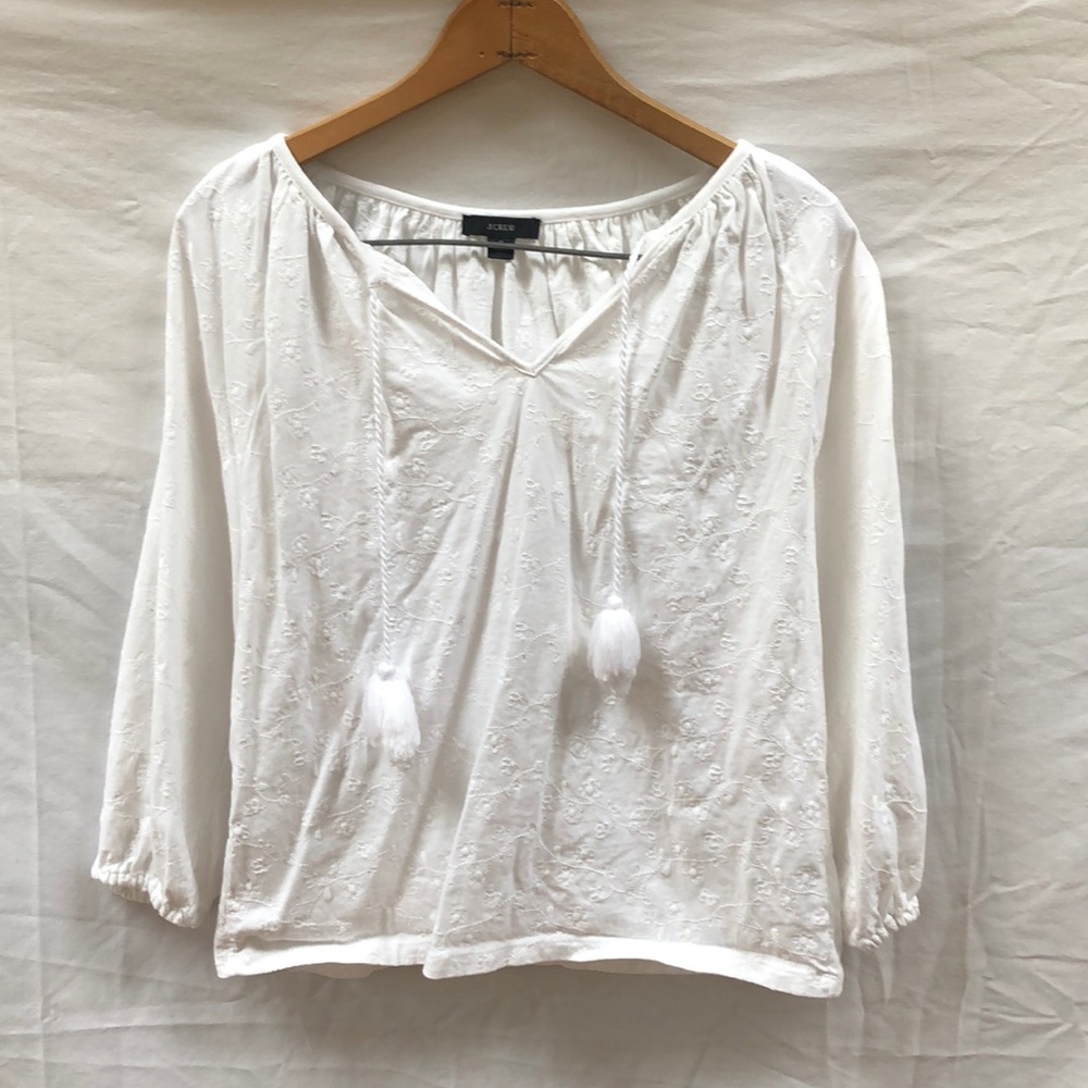 White blouse with floral embroidered details